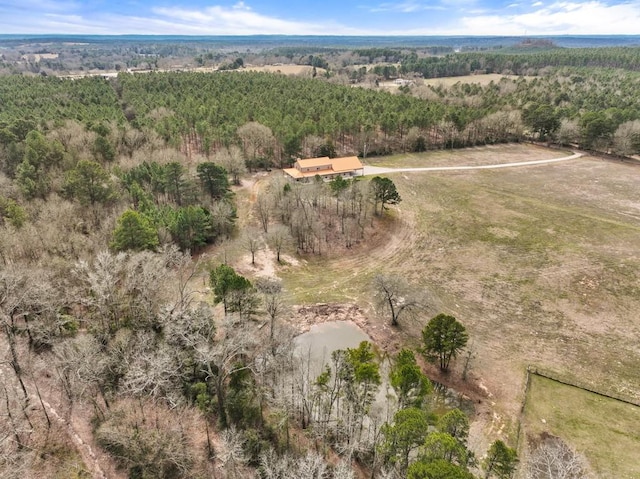 birds eye view of property featuring a forest view