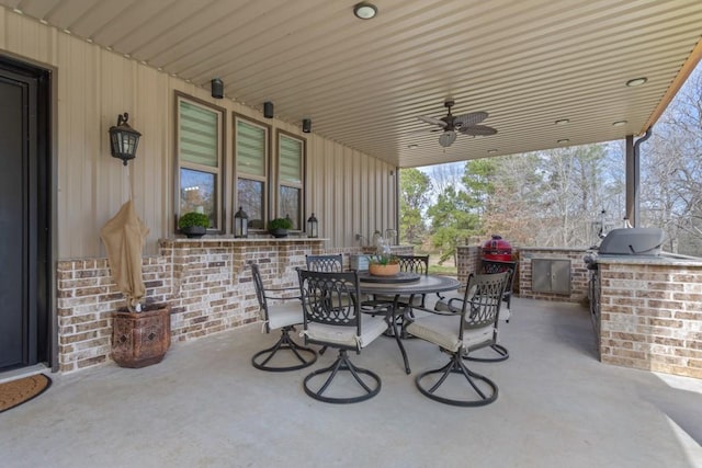 view of patio / terrace featuring ceiling fan, exterior kitchen, and outdoor dining space