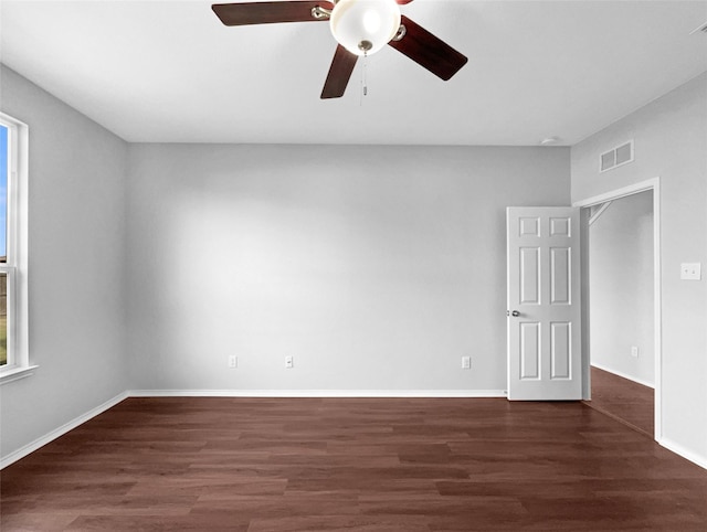 unfurnished room featuring visible vents, ceiling fan, baseboards, and wood finished floors