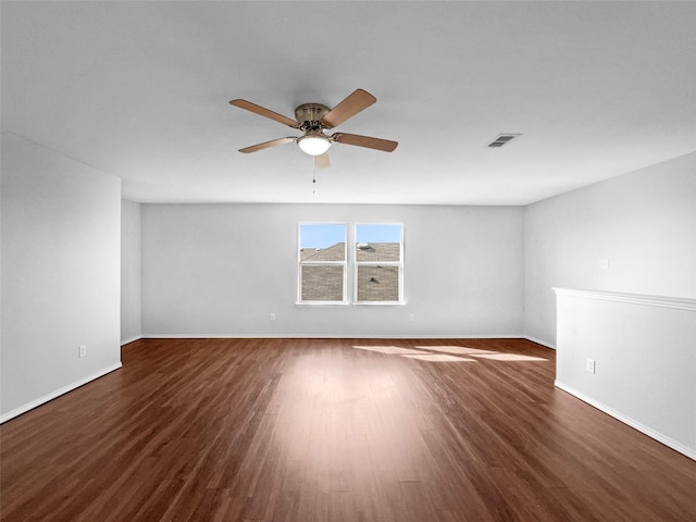 unfurnished room featuring baseboards, wood finished floors, visible vents, and a ceiling fan