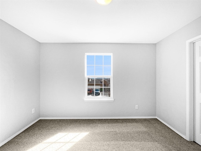 carpeted spare room with baseboards