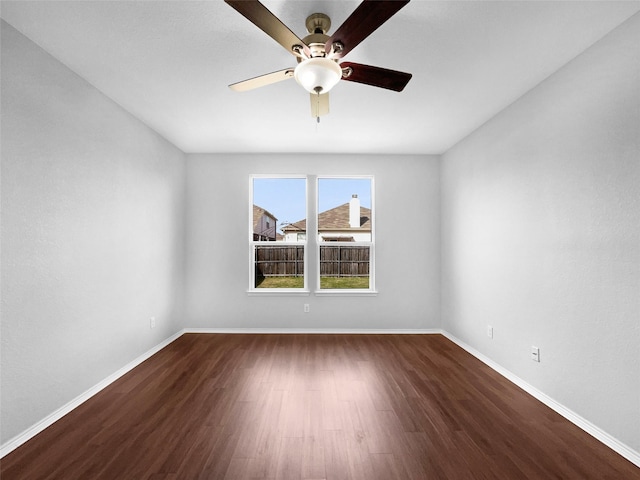 empty room featuring ceiling fan, baseboards, and wood finished floors