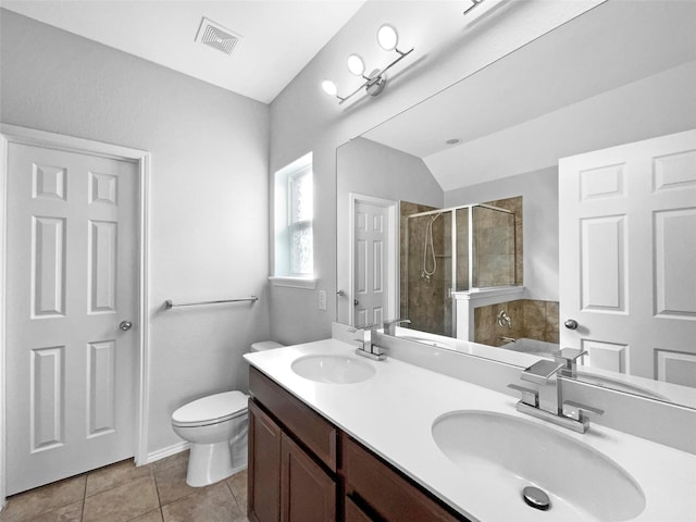 bathroom with a stall shower, visible vents, a sink, and toilet