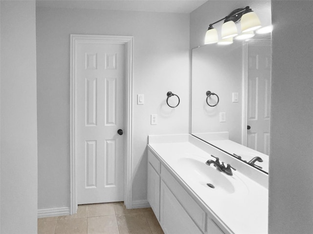 bathroom featuring tile patterned flooring, baseboards, and vanity