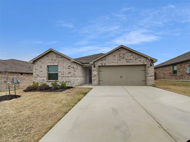 single story home featuring a garage, brick siding, driveway, and a front lawn