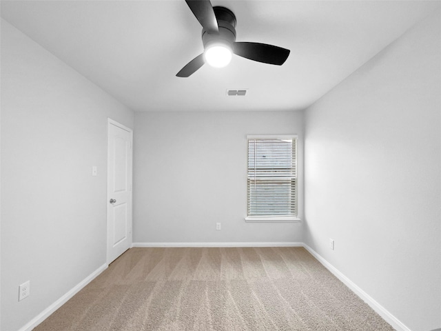 empty room with a ceiling fan, baseboards, visible vents, and carpet flooring