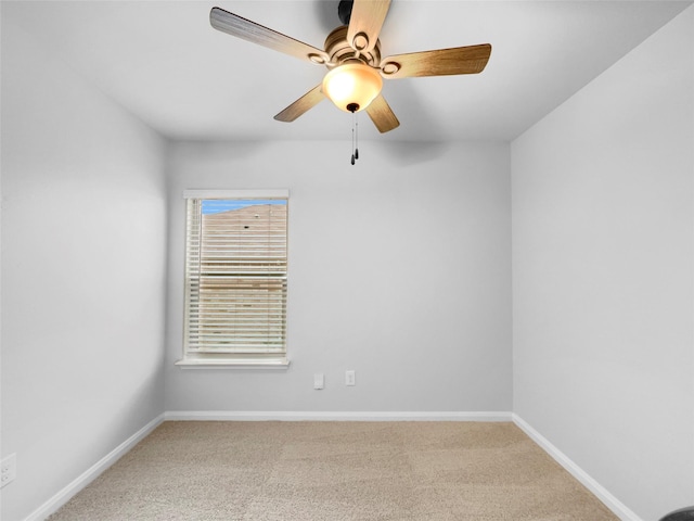 unfurnished room with light carpet, baseboards, and a ceiling fan