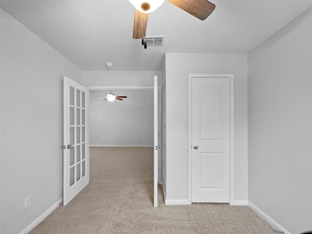 interior space featuring carpet flooring, visible vents, and baseboards