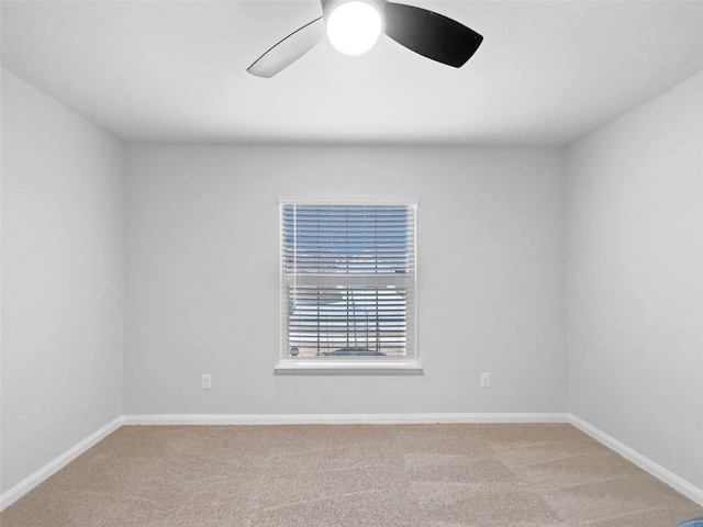 empty room featuring a ceiling fan, carpet flooring, and baseboards