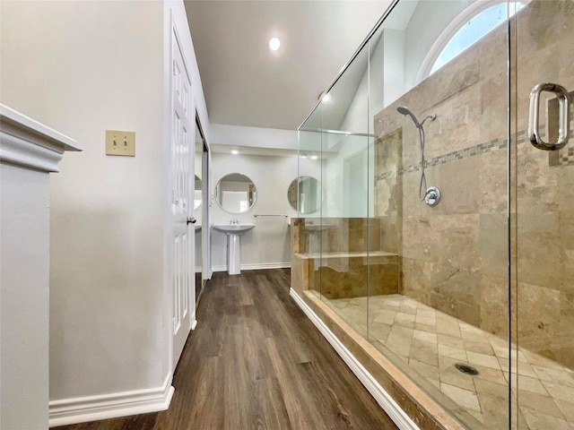 full bathroom featuring a stall shower, wood finished floors, and baseboards