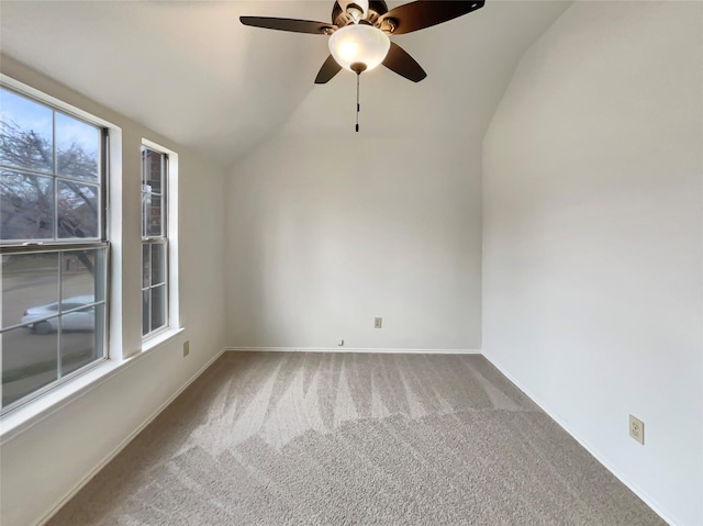 empty room with lofted ceiling, baseboards, and carpet flooring