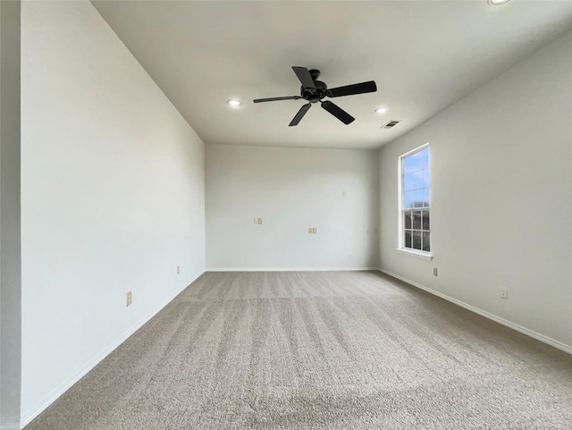 carpeted spare room featuring ceiling fan, recessed lighting, and baseboards