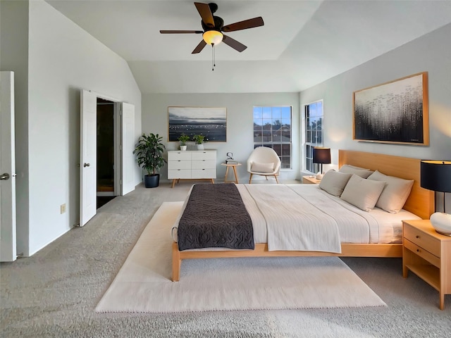 bedroom with ceiling fan, carpet floors, and lofted ceiling