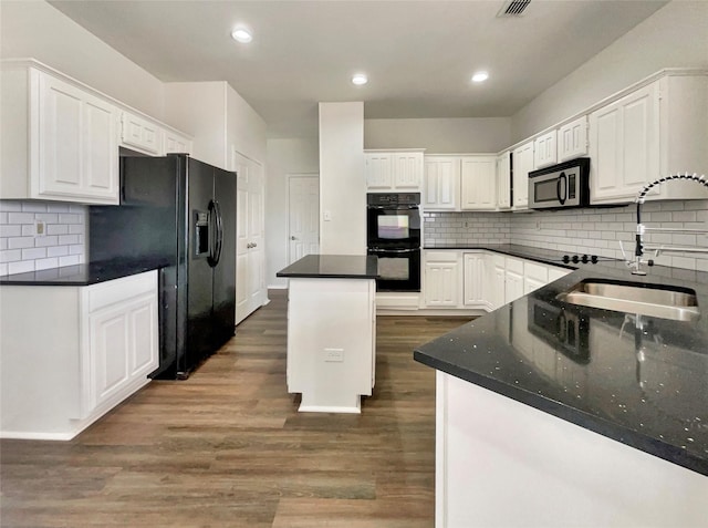 kitchen featuring a kitchen island, dark wood-type flooring, black appliances, white cabinetry, and a sink