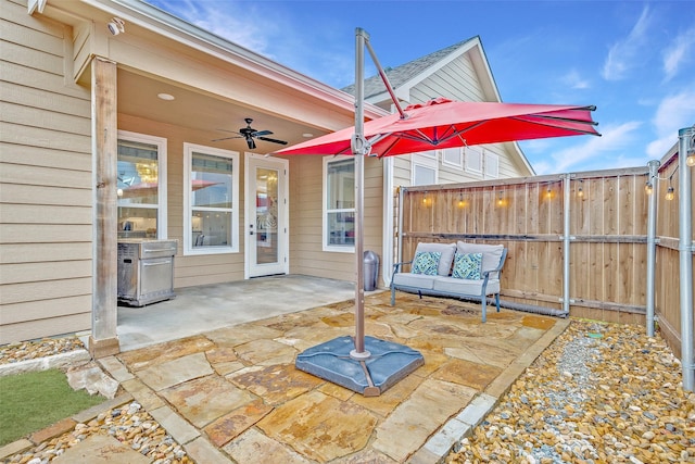 view of patio with a ceiling fan and fence