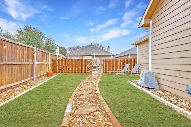 view of yard with a fenced backyard