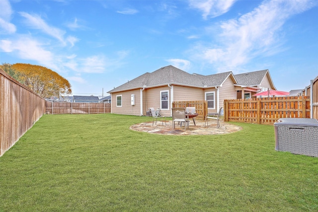 back of house with a patio area, a lawn, and a fenced backyard