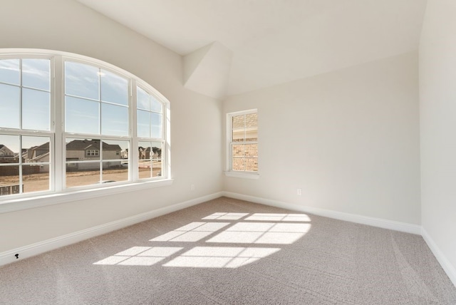 carpeted empty room with baseboards