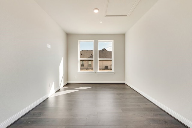 unfurnished room with dark wood-style floors and baseboards