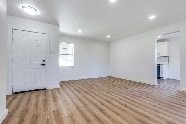 entryway featuring baseboards, recessed lighting, and light wood-style floors