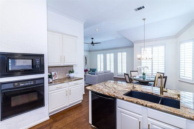 kitchen with ornamental molding, visible vents, a sink, and black appliances