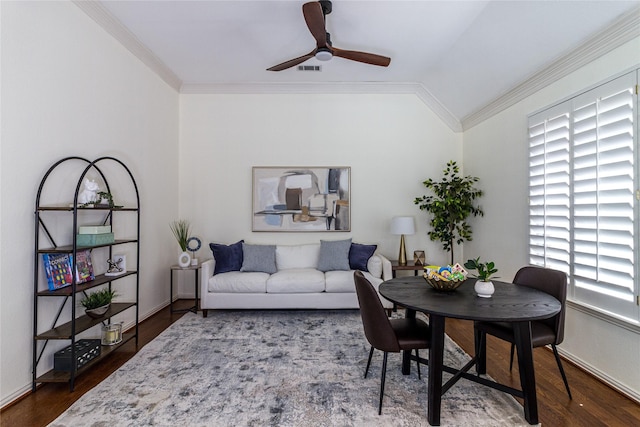 interior space featuring lofted ceiling, crown molding, baseboards, and wood finished floors