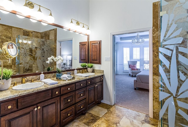 ensuite bathroom with double vanity, a towering ceiling, ensuite bathroom, walk in shower, and a sink