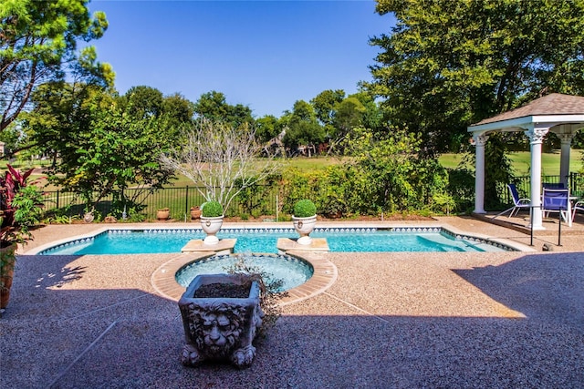 view of swimming pool with a patio area, a fenced backyard, a fenced in pool, and a gazebo