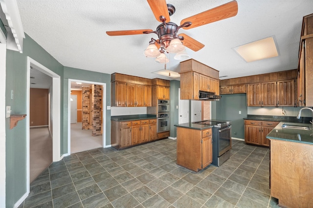 kitchen with electric range oven, dark countertops, brown cabinets, ventilation hood, and a sink