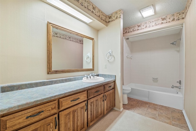 bathroom with toilet, vanity, a textured ceiling,  shower combination, and tile patterned flooring