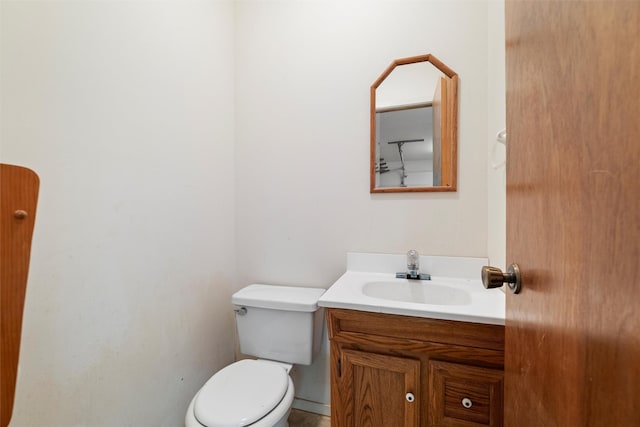 half bathroom with toilet and vanity