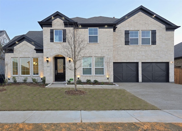 view of front of property featuring driveway, a front lawn, an attached garage, a shingled roof, and brick siding