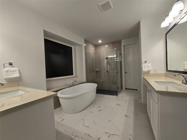 full bath featuring a stall shower, marble finish floor, and a sink