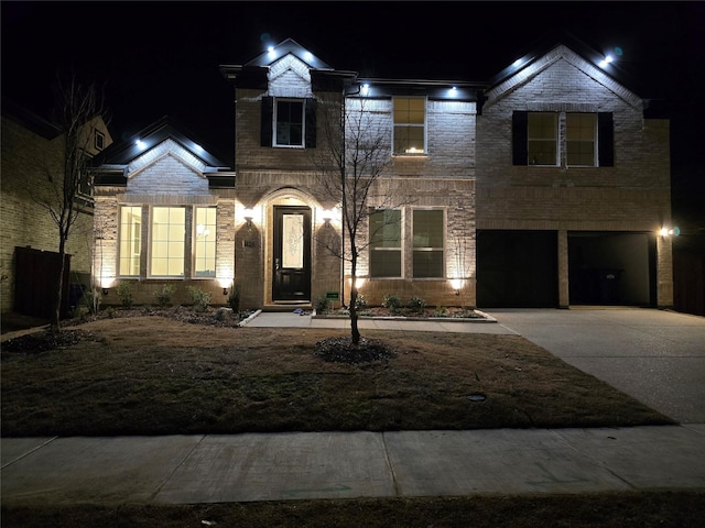 traditional home with a garage, concrete driveway, and brick siding