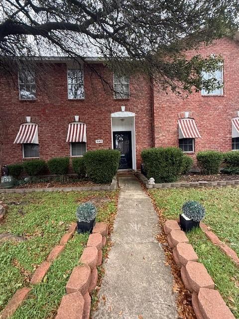 view of front of home with brick siding