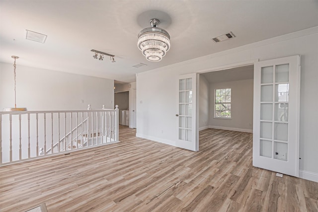 1542 Home Park Dr, Allen, TX 75002 - empty room with a chandelier, light wood-style floors, baseboards, french doors, and track lighting