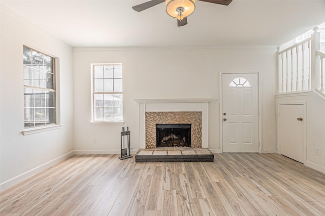 1542 Home Park Dr, Allen, TX 75002 - unfurnished living room featuring ceiling fan, light wood-style floors, healthy amount of natural light, and crown molding
