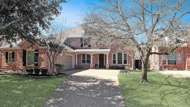 view of front of house with concrete driveway, a front lawn, an attached garage, and brick siding