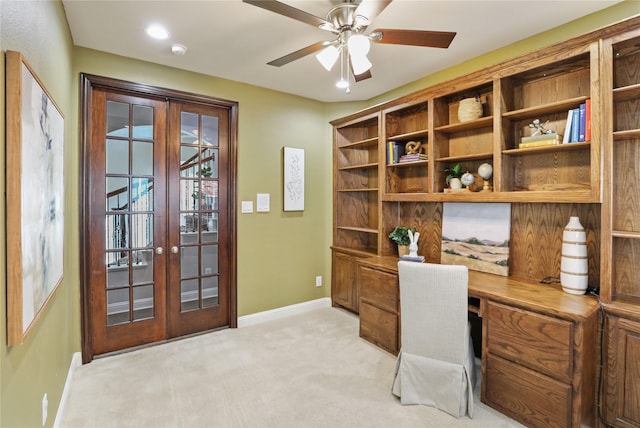 office space with light carpet, french doors, baseboards, and a ceiling fan