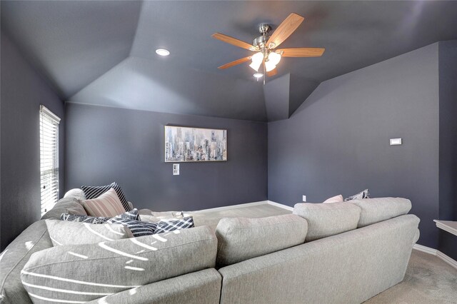 cinema room with vaulted ceiling, carpet floors, a ceiling fan, and baseboards