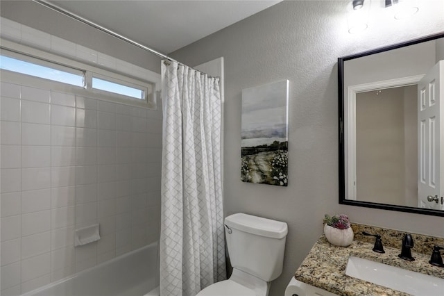 bathroom with shower / bath combo, vanity, and toilet