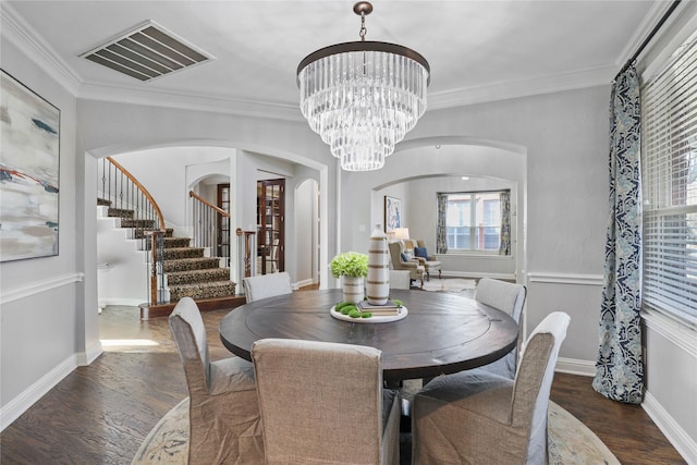 dining area with a wealth of natural light, visible vents, arched walkways, and stairway