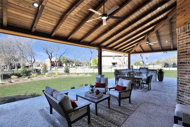 view of patio featuring ceiling fan, grilling area, fence, outdoor lounge area, and outdoor dining space