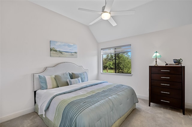 bedroom featuring light carpet, vaulted ceiling, baseboards, and ceiling fan