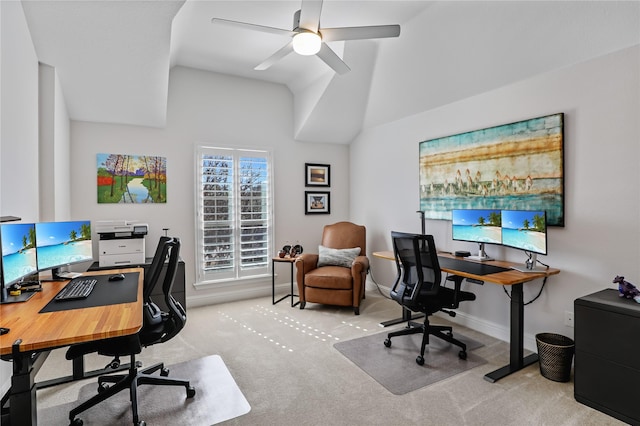 carpeted office with lofted ceiling, baseboards, and a ceiling fan