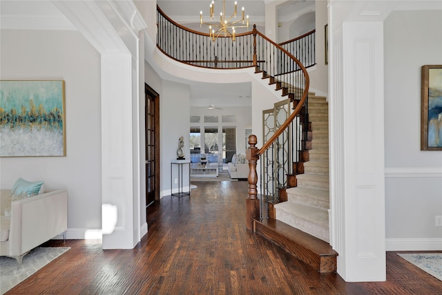 entrance foyer with crown molding, stairway, baseboards, and wood finished floors