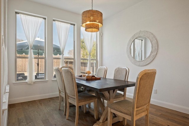 dining space with dark wood-style floors and baseboards