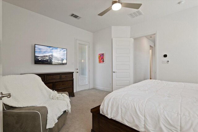 carpeted bedroom featuring a ceiling fan, visible vents, and baseboards