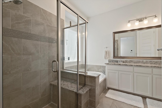 full bath with a stall shower, tile patterned floors, a garden tub, and vanity