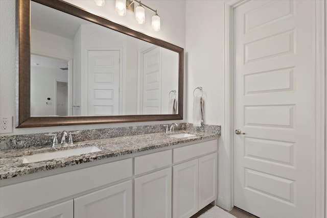 full bathroom featuring a sink and double vanity